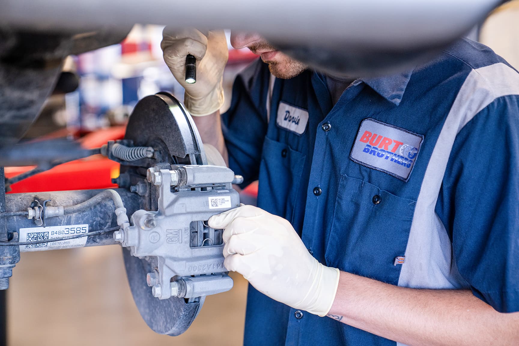 Burt Brothers mechanic inspecting brakes