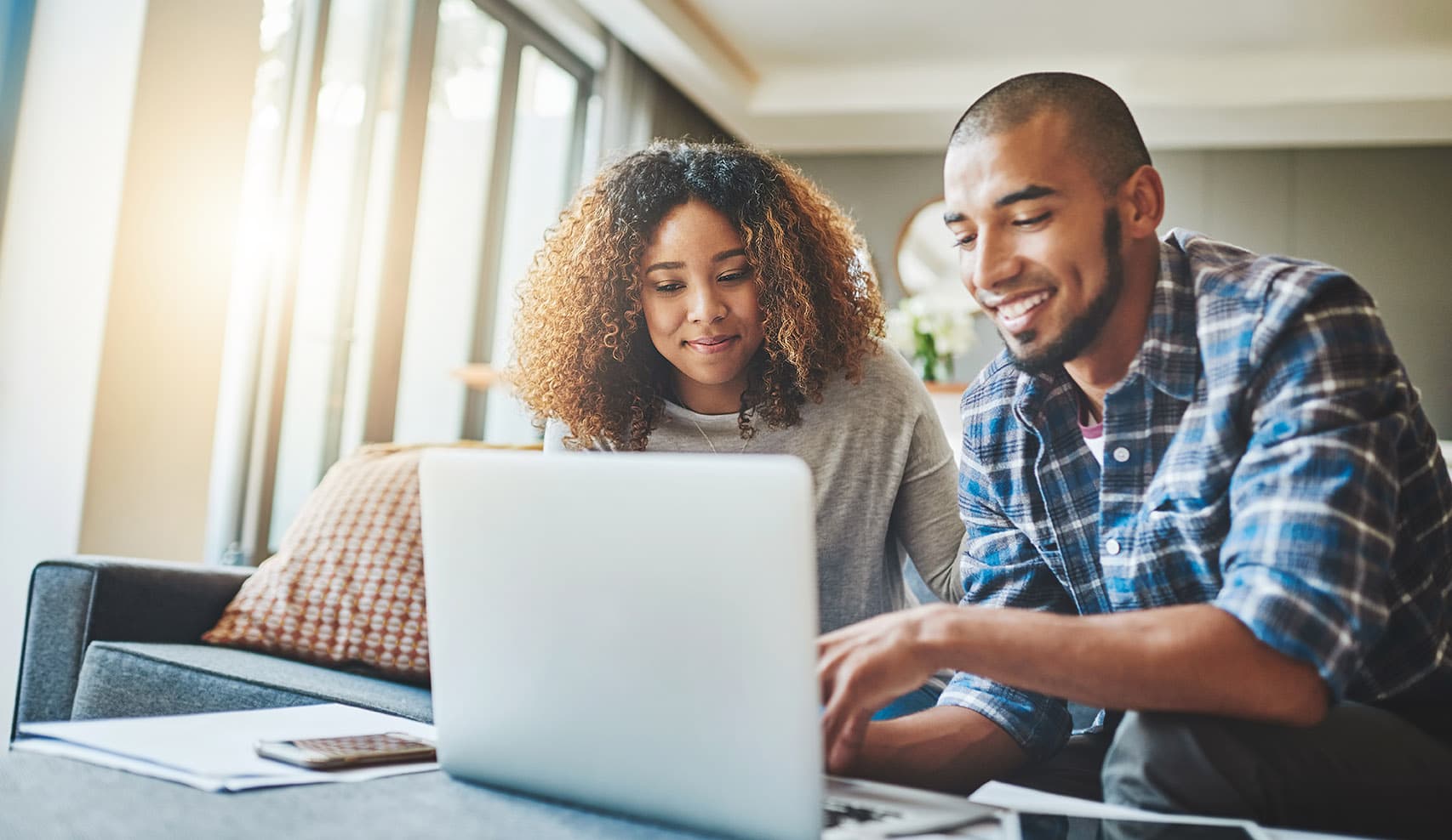 Couple reviewing financing options on laptop